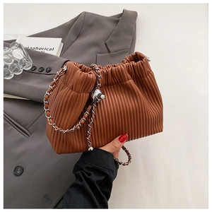 Detail of brown pleated cloud bag with silver chain strap and spherical metal buckle