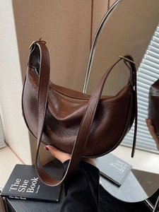 Retro dark brown crescent shoulder bag in glossy leather with gold adjustable buckle
