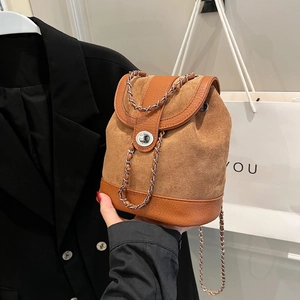 Brown minimalist mini backpack with matte texture and silver chain lock closure for women