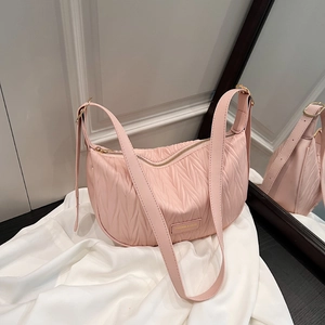 Pink pleated dumpling shoulder bag with metallic logo and adjustable strap for women