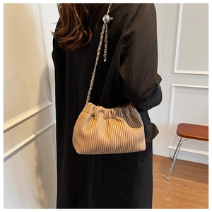 Detail of khaki pleated cloud bag with silver chain and adjustable metal ball strap