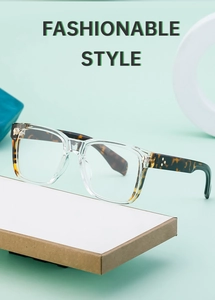 Detail of square glasses with transparent frames, tortoiseshell temples and metal accents