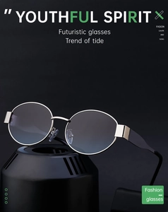 Close-up of retro round metal frame sunglasses with blue gradient lenses on display