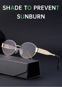 Detail of vintage oval gold metal sunglasses with gradient lenses and a folding case
