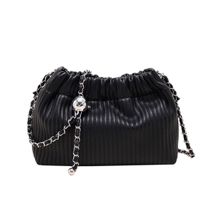 Modern black pleated bucket bag with silver chain strap and decorative metallic ball