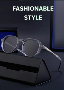 Detail of translucent gray square sunglasses with silver metal temples on a black case