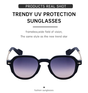 Detail of vintage square sunglasses with purple gradient lenses and gold metal hinges