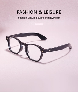 Detail view of glossy black square frame glasses with golden decorative accents