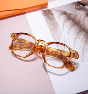 Detail of round tortoiseshell eyeglass frames with specifications on purple background