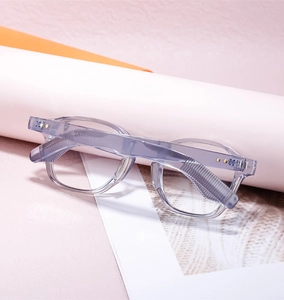 Close-up of translucent grey-blue square frame with star-shaped gold metal rivets