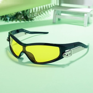 Close-up of sports sunglasses with yellow lenses and metallic temple hinge detail
