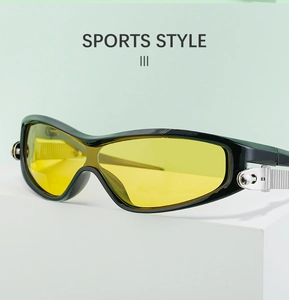 Detail of sports sunglasses featuring a black glossy frame and yellow tinted lenses