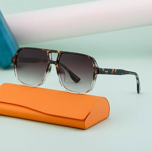 Vintage double bridge aviator sunglasses with tortoiseshell frames and orange case
