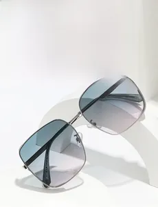 Detail view of silver metal frame sunglasses with blue to purple gradient polarized lenses