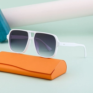 Retro double-bridge sunglasses with white large frame and gray gradient lenses on orange case