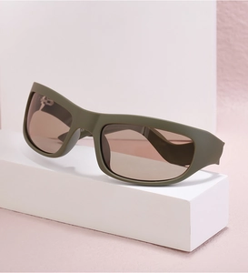 Detailed macro view of olive green matte frame and gradient brown lenses on athletic sunglasses