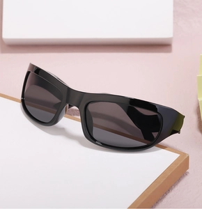 Detailed view of black wrap-around Y2K sports sunglasses on a stylish geometric display