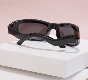 Detailed side view of Y2K sports sunglasses featuring unique thick wavy temples in black