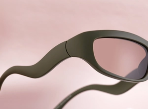 Detail of olive green matte sports sunglasses with unique wave-shaped temples