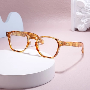 Retro amber tortoiseshell round glasses frame for men and women on a marble display
