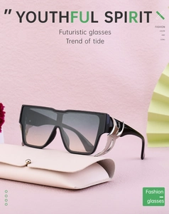 Detail of futuristic square sunglasses with silver flame accents and a leather case