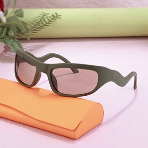 Y2K sporty sunglasses with olive green frame and orange case on a modern background