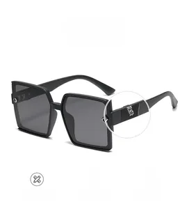 Detailed view of square frame sunglasses with intricate hollowed-out metal temple carvings