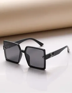 Detail of square oversized polarized sunglasses with metal cutout decoration and rhinestones
