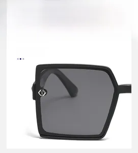 Close-up of black square sunglasses frame with geometric metal detail on the temple