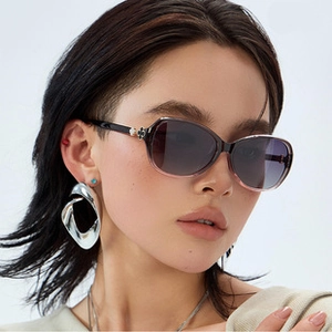 Detail of square polarized sunglasses with floral temple decor and geometric earrings