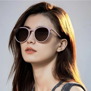 Close-up of woman wearing pink polarized square sunglasses in outdoor natural sunlight