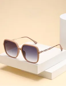 Detail of polarized square sunglasses with gradient lenses and rose gold chain-link temples