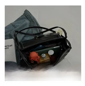 Interior view showing spacious compartments for umbrella and phone in black leather bag