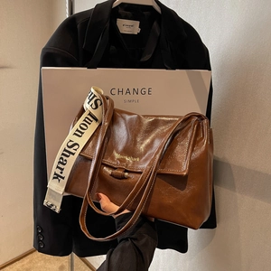 Deep brown retro crossbody bag with embroidered wide strap and polished leather finish