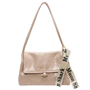 Minimalist beige crossbody bag with metal buckle and Muon Shark decorative ribbon