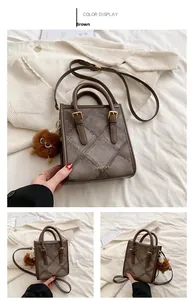 Close-up of brown small square tote bag with quilted fabric and leather stitching