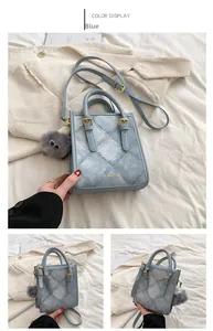 Blue denim texture handbag with golden logo and grey fur ball charm detail