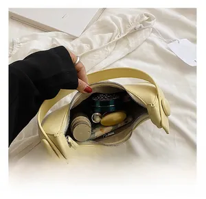 Internal view of the yellow crescent shoulder bag showing ample storage capacity