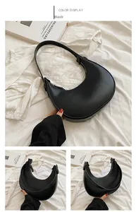 Detailed macro view of black crescent shoulder bag with smooth texture and metal zipper