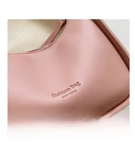 Close-up of pink PU leather texture with New York embossed text on fashionable handbag