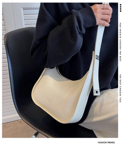 Detail of cream PU leather half-moon hobo bag with adjustable strap and silver buckle