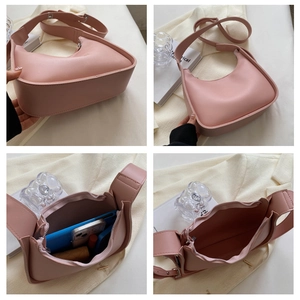 Detailed views of pink crescent shoulder bag showing interior capacity and smooth PU texture