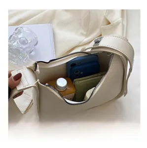 Detail showing the large interior capacity of this cream crescent shoulder bag