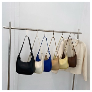 Detailed display of six minimalist crescent moon shoulder bags in various matte leather colors