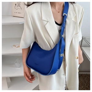 Detail of blue crescent crossbody bag with adjustable wide strap and silver buckle