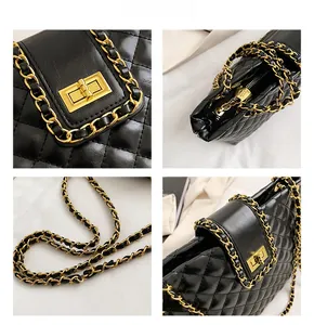 Detailed close-up of black quilted tote bag with gold chain strap and metal clasp
