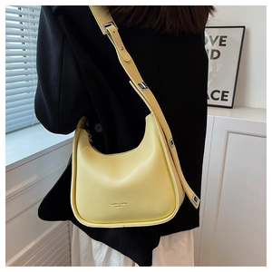 Detail of a lemon yellow hobo shoulder bag with adjustable strap and silver metal buckle