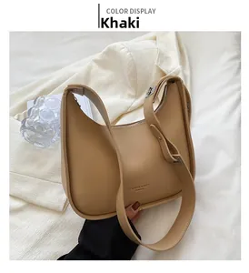 Detail of khaki crescent shoulder bag with smooth leather finish and zipper closure
