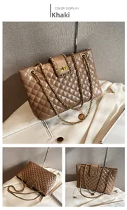 Detail of khaki quilted leather tote featuring golden chain straps and turn-lock closure