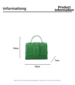 Detailed view of green croc-embossed leather handbag with 15x14x7cm size dimensions